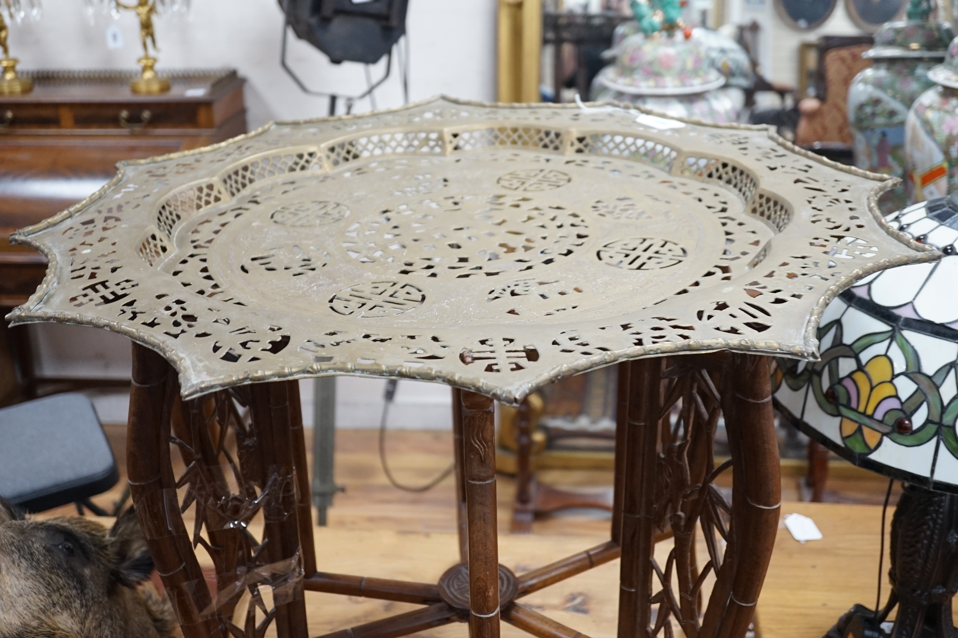 A Chinese circular fretted brass topped folding occasional table, diameter 82cm, height 62cm